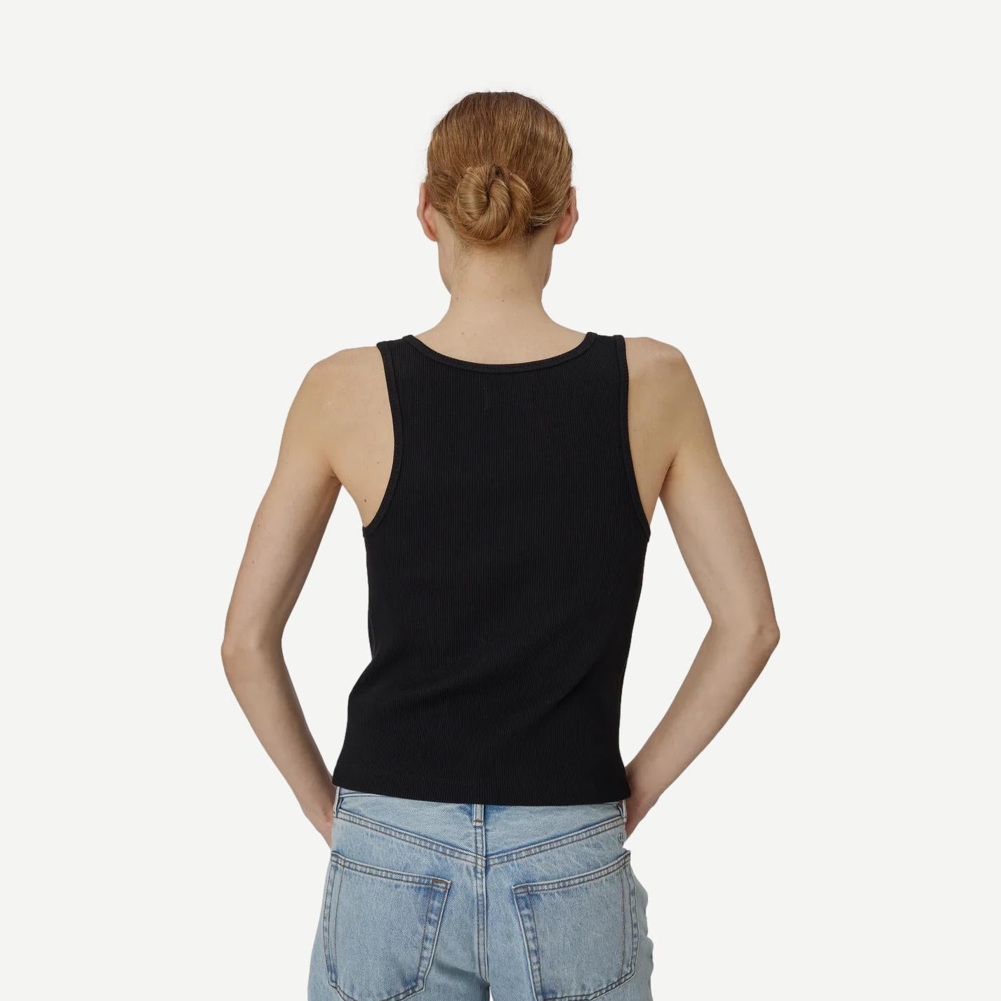 Still Here Snap Tank in black, sleeveless tank top with a relaxed fit, shown on a model.