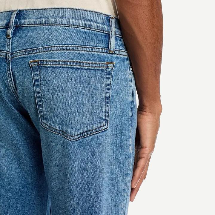 Light blue Frame Denim Modern Straight Jean in crosswalk wash, showcasing classic denim fit and clean stitching detail.