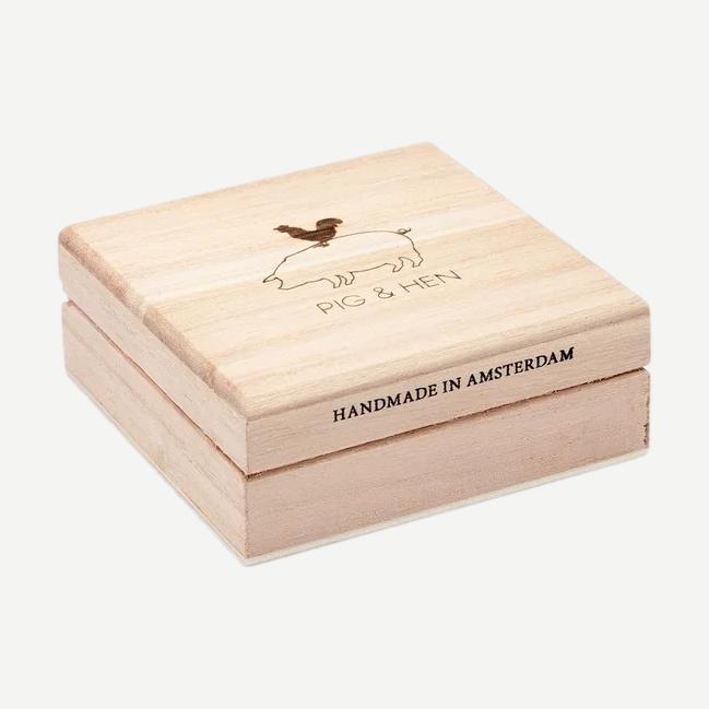 Black and black PH Salty Steve bracelet by Pig & Hen displayed in a box showing its sleek design and branding.