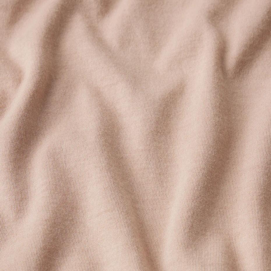 Light pale peach cotton T-shirt by Frame Denim, short-sleeve, soft fabric, displayed on a white background.
