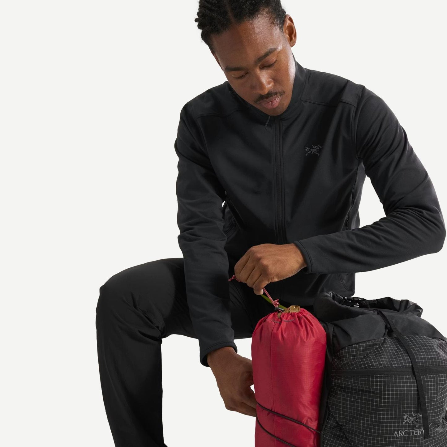 Black Arcteryx Kyanite lightweight jacket shown on a hanger, featuring a sleek design and minimal branding.