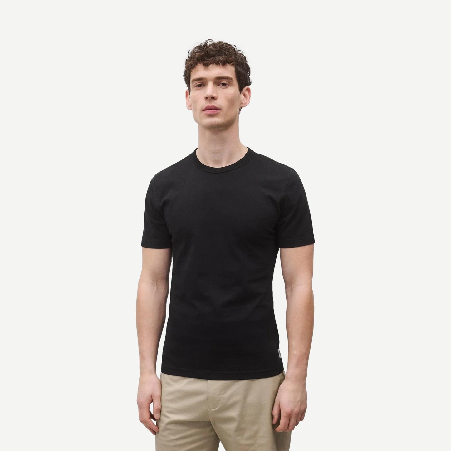 Black Reigning Champ lightweight jersey slim T-shirt displayed on a model, showcasing its sleek fit and soft fabric.