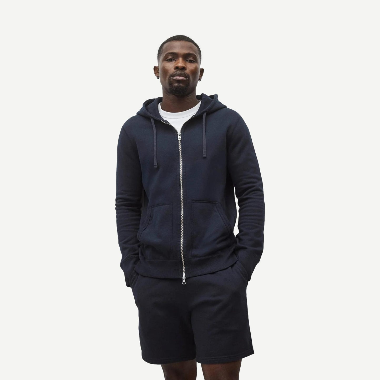 Reigning Champ navy midweight terry slim zip hoodie, front view showing full zipper and hoodie details.