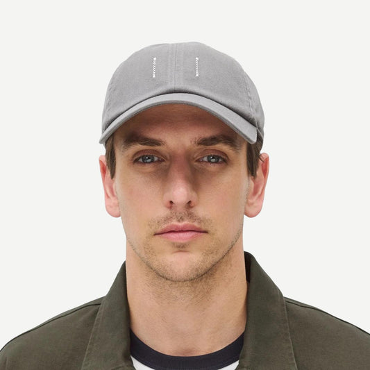 Reigning Champ cotton chino low pro strapback cap in washed grey, front view showing classic hat style and adjustable strap.