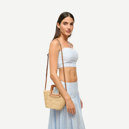 Staud Shirley Raffia Mini Bucket purse in natural and tan with woven raffia texture and small rounded shape.