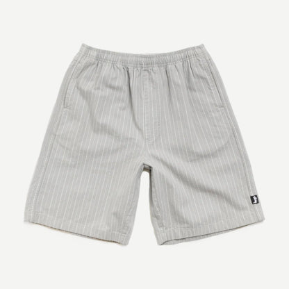Stussy Baggy Beach Shorts in grey, loose fit with elastic waistband, casual summer shorts displayed on a model.