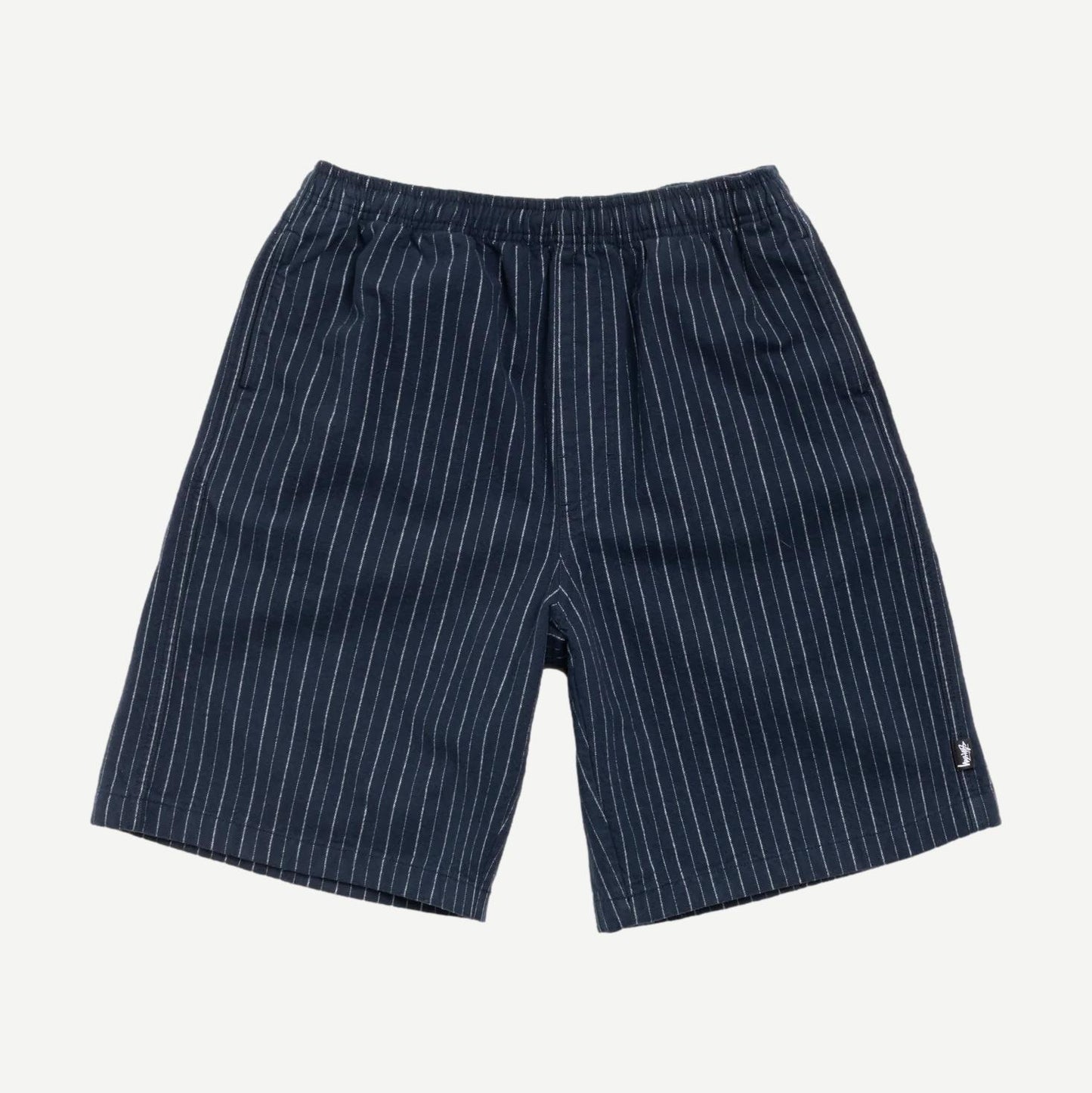 Navy Stussy Baggy Beach Shorts laid flat showing relaxed fit and lightweight fabric perfect for casual beachwear.