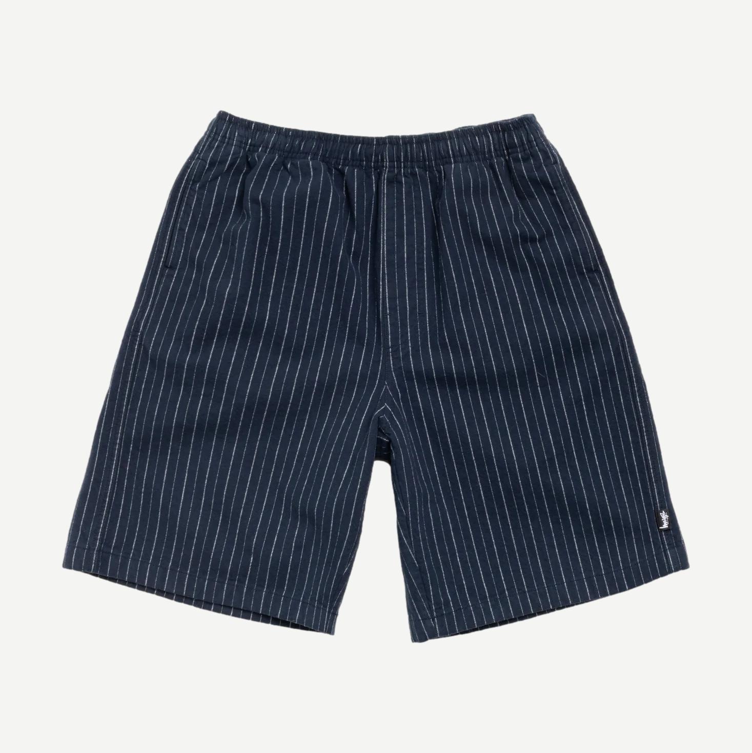 Navy Stussy Baggy Beach Shorts laid flat showing relaxed fit and lightweight fabric perfect for casual beachwear.