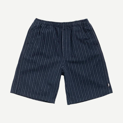Navy Stussy Baggy Beach Shorts laid flat showing relaxed fit and lightweight fabric perfect for casual beachwear.