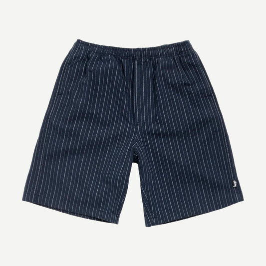 Navy Stussy Baggy Beach Shorts laid flat showing relaxed fit and lightweight fabric perfect for casual beachwear.