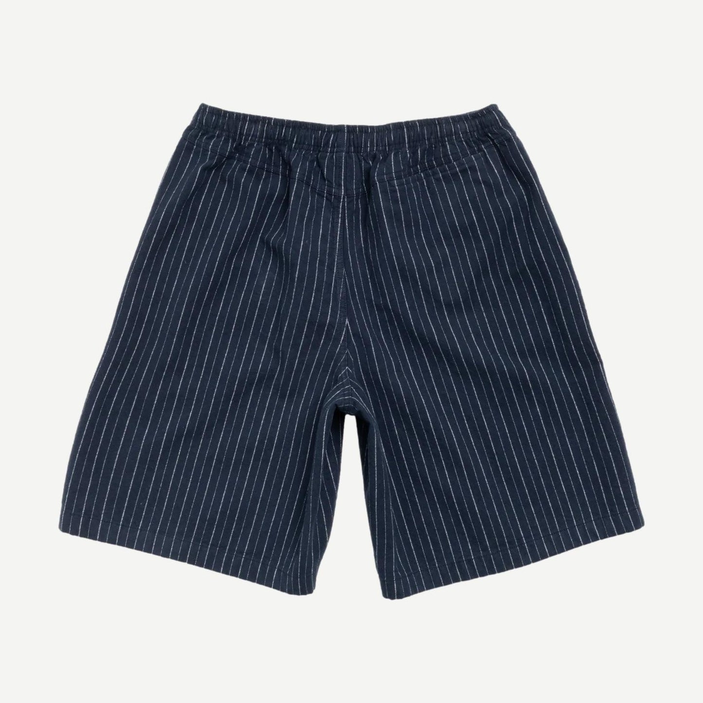 Stussy baggy navy beach shorts with relaxed fit, elastic waistband, and side pockets, ideal for casual summer wear.