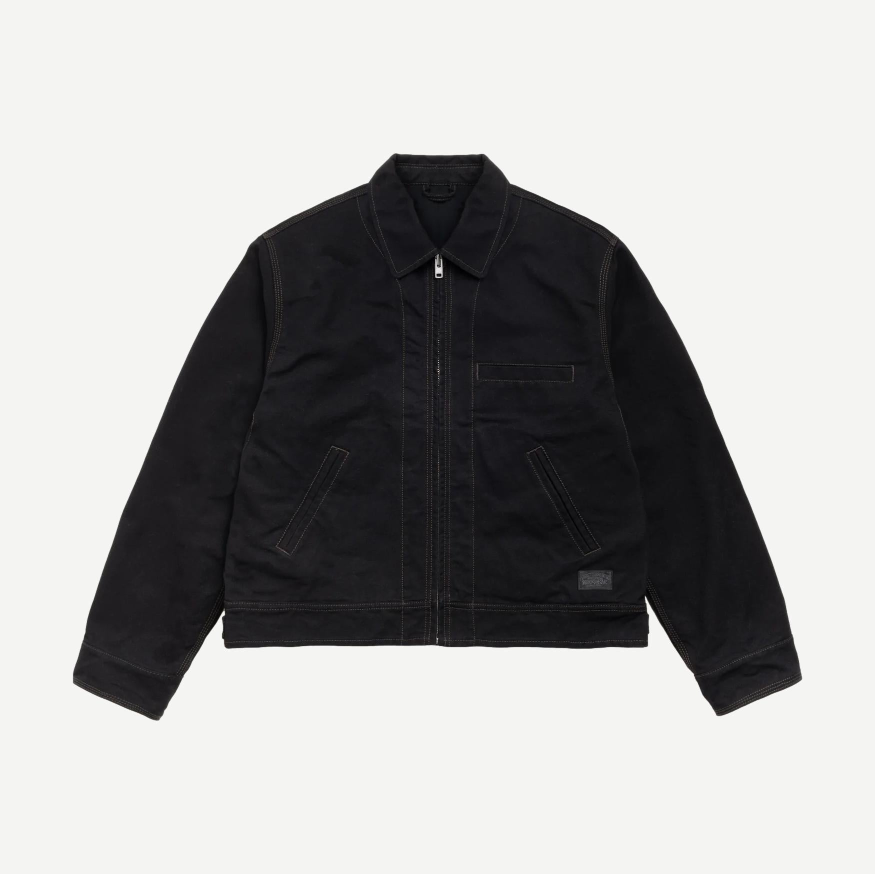 Black Stussy work jacket with a collared design, featuring durable fabric and practical style, ideal for casual or workwear.