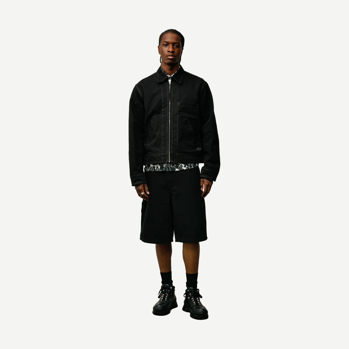 Black Stussy work jacket with a collared design, featuring a sleek, durable fabric and classic fit for casual or workwear.