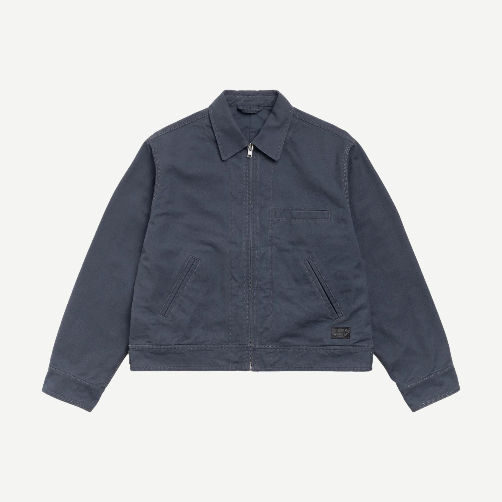 Blue Stussy work jacket with collar, featuring a casual design and button front, suitable for workwear and outdoor activities.