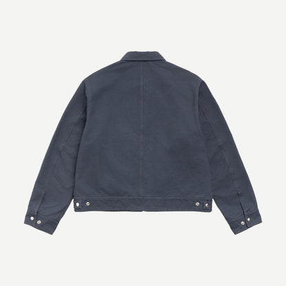 Stussy blue work jacket with collar, durable cotton fabric, front pockets, and stylish design for casual and workwear.