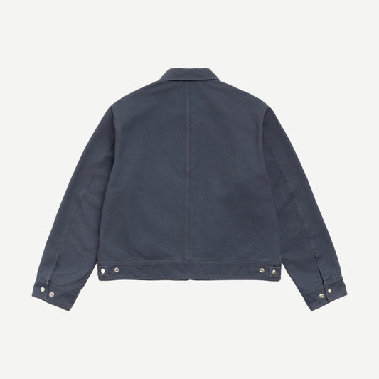 Stussy blue work jacket with collar, durable cotton fabric, front pockets, and stylish design for casual and workwear.