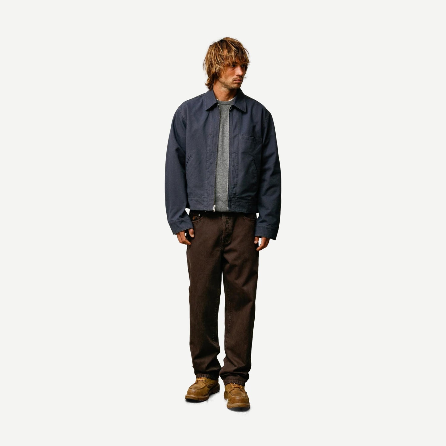 Stussy blue work jacket with a collared design, featuring a sturdy fabric and practical style for casual or workwear use.