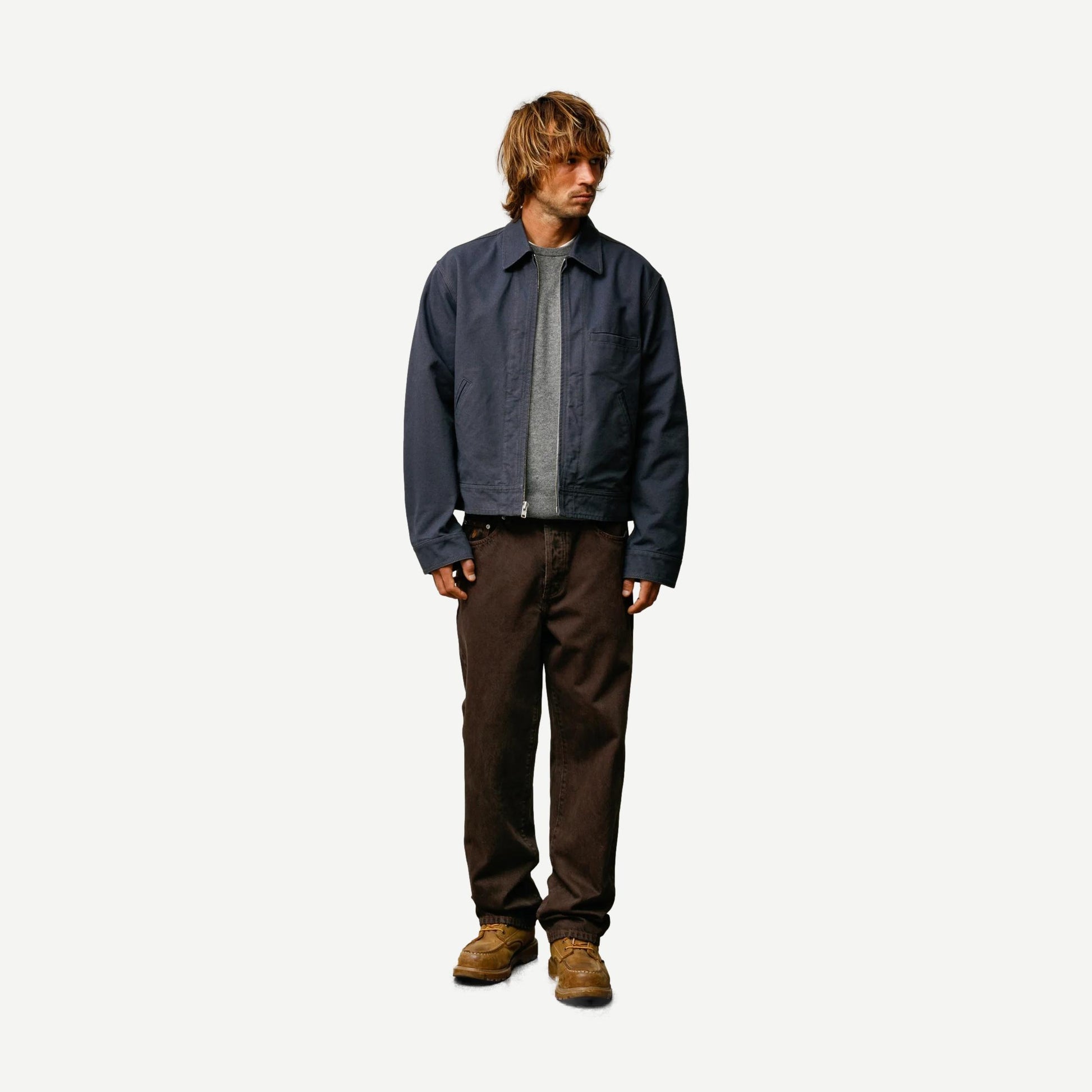 Stussy blue work jacket with a collared design, featuring a sturdy fabric and practical style for casual or workwear use.