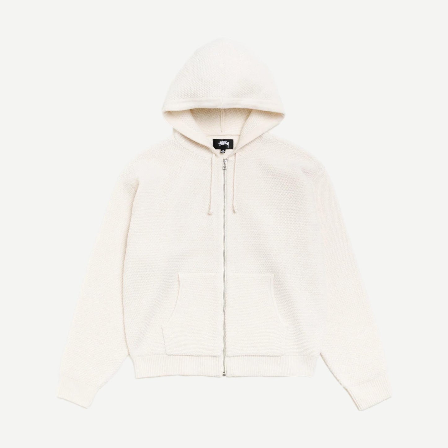 Stussy textured zip hooded sweater in bone color, featuring a hood, front zipper, and cozy fabric, casual streetwear style.