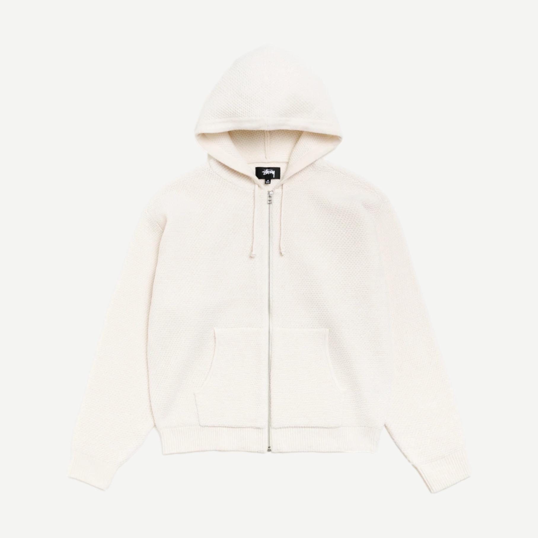 Stussy textured zip hooded sweater in bone color, featuring a hood, front zipper, and cozy fabric, casual streetwear style.