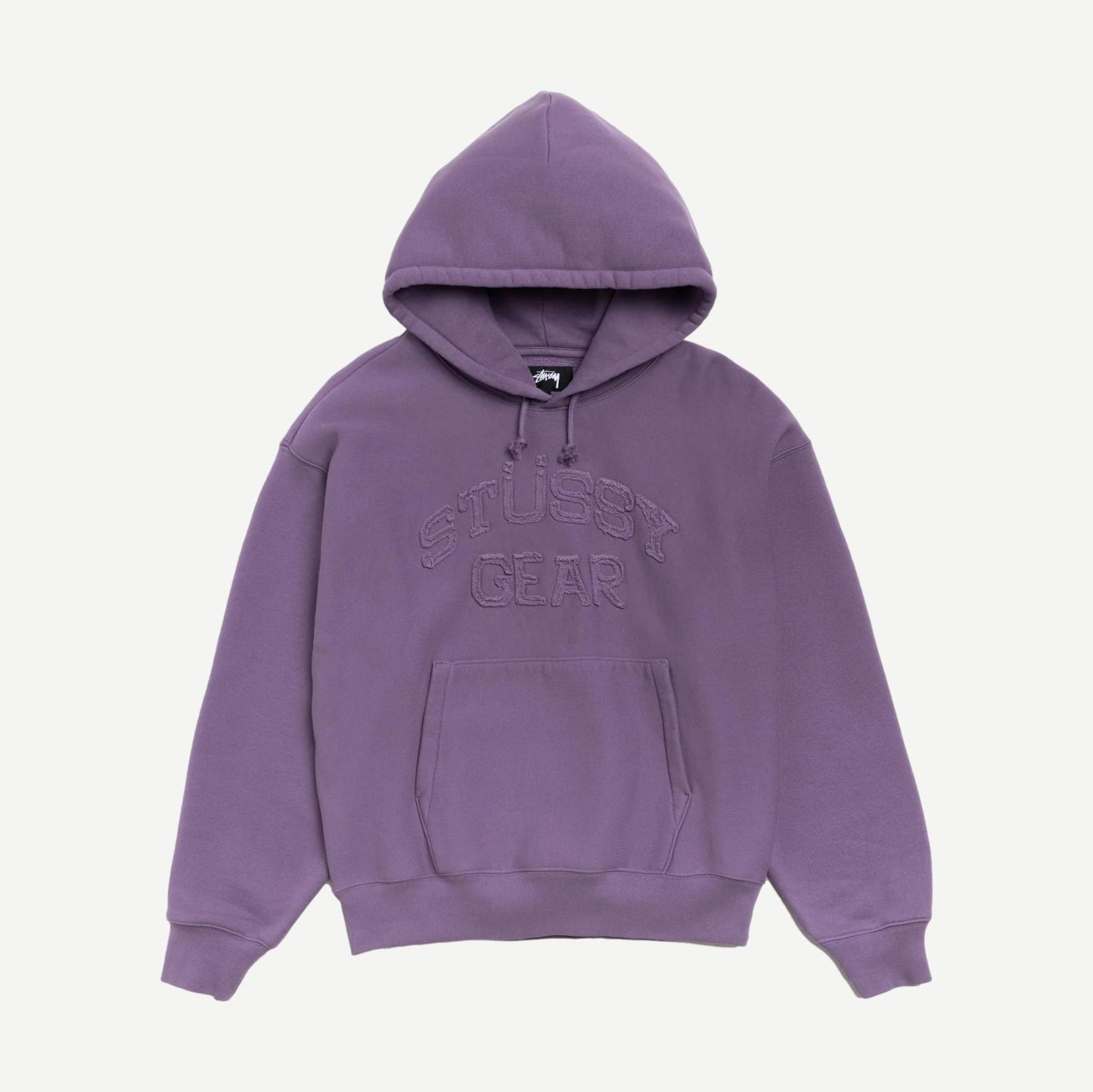 Stussy purple Gear Applique Hood sweatshirt with a visible front logo and cozy fabric, shown in a close-up image.