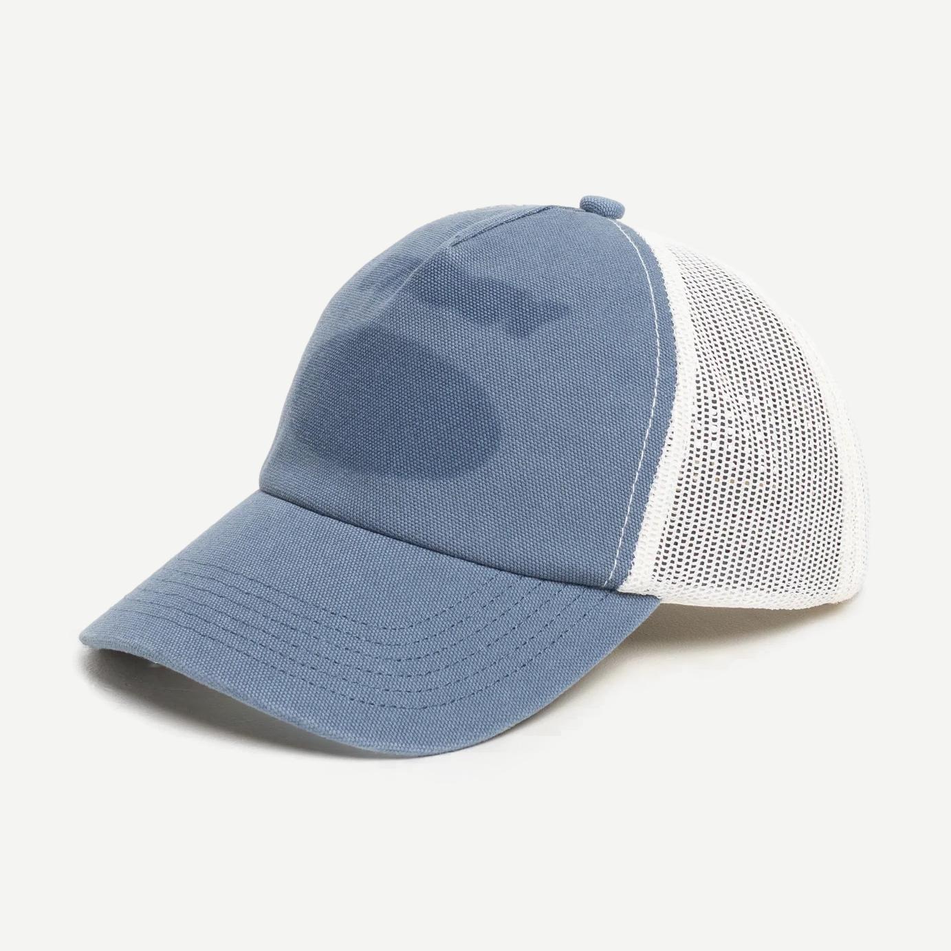 Stussy HP Ghost Logo Trucker Hat in blue featuring a front logo patch and mesh back for casual style.