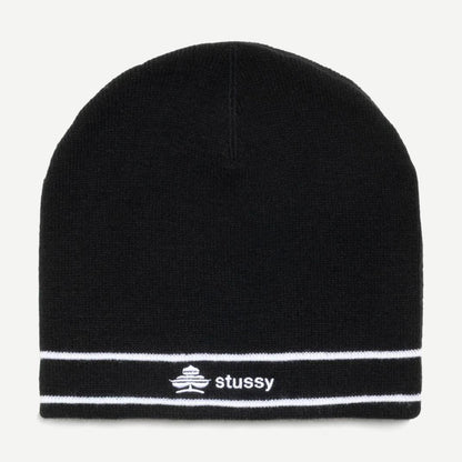 Black Stussy Clover Skullcap beanie shown on a model, featuring a snug fit and the signature Stussy logo.