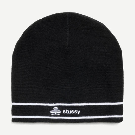 Black Stussy Clover Skullcap beanie shown on a model, featuring a snug fit and the signature Stussy logo.