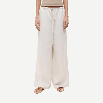 Staud Mateo linen pants in natural color, featuring a relaxed fit and lightweight fabric, displayed on a neutral background.