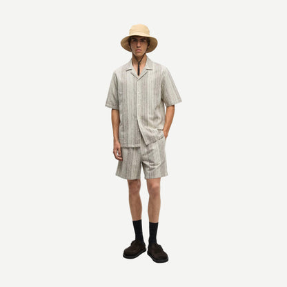 Samsoe Samsoe Oscar AX brown shirt displayed on a hanger, showcasing the casual design and fabric details.