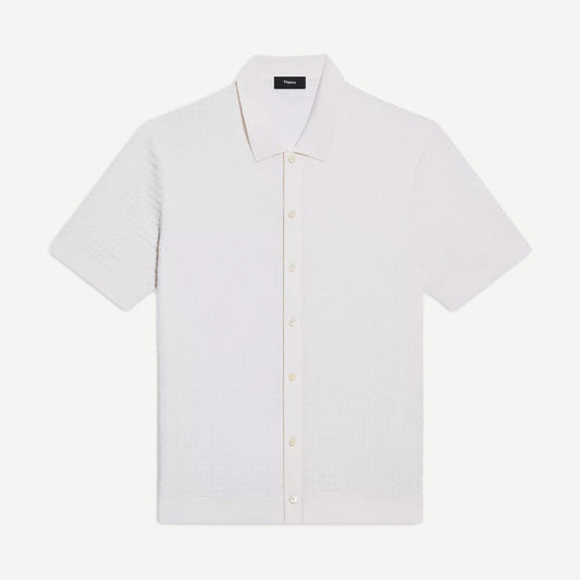 Theory Cairn SS Button Up shirt in winter ivory, featuring a classic design with a collar and button front, displayed on a hanger.