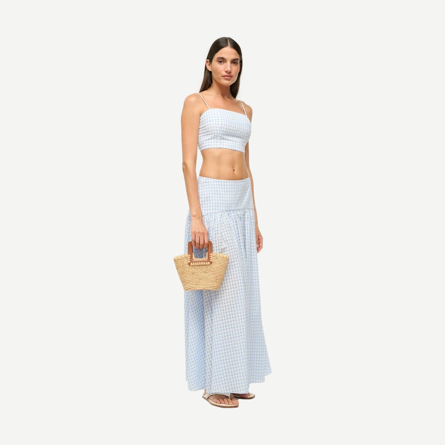 Staud Shirley Raffia Mini Bucket purse in natural tan with woven raffia texture and short handle, stylish accessory for casual outfits.