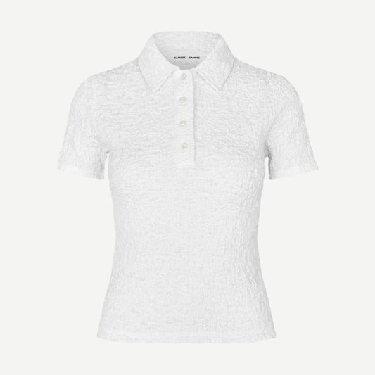 White Sadaisy SS Polo shirt by Samsoe Samsoe displayed on a hanger with close-up of fabric and collar details.