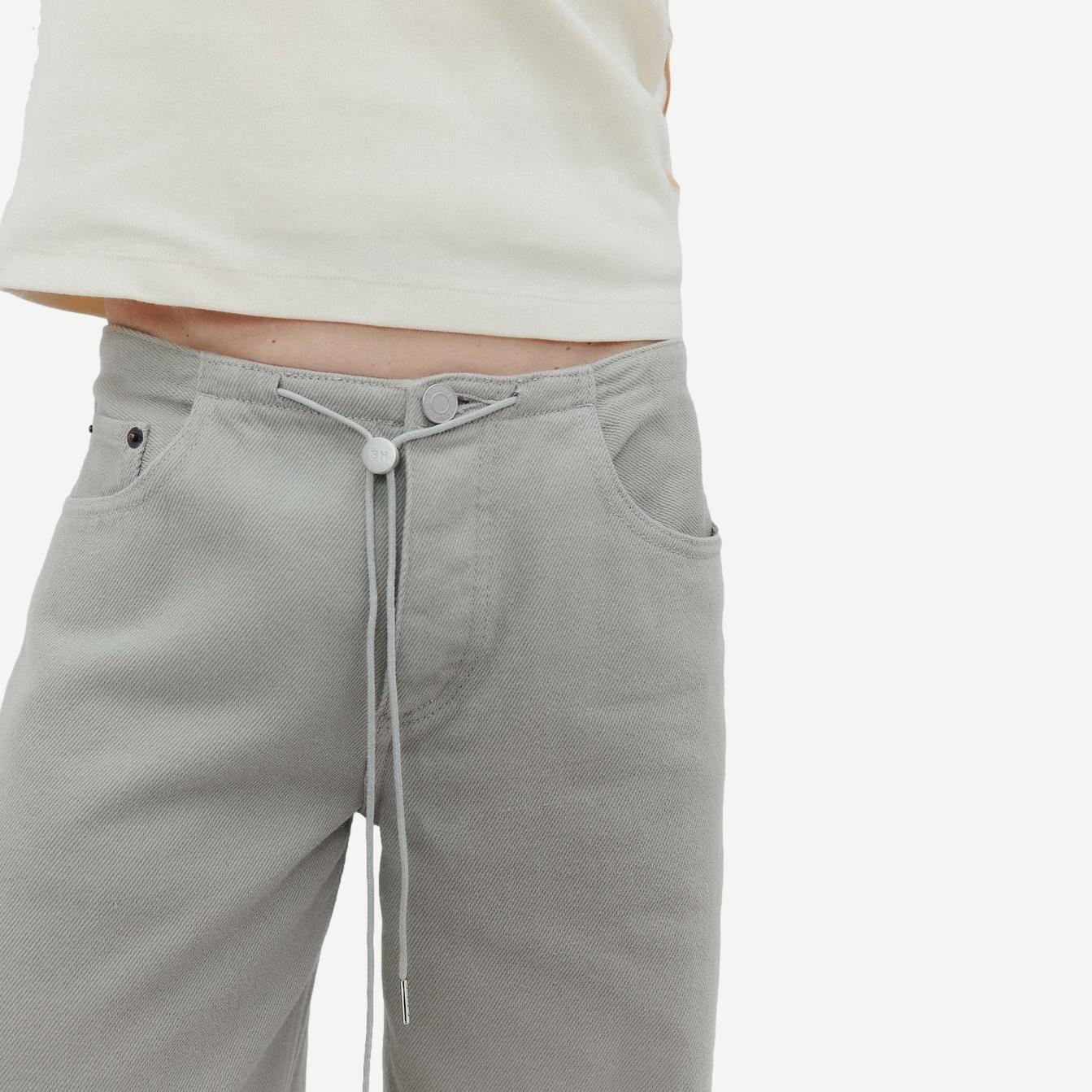 Still Here Cool Jean in Dust denim, showcasing relaxed fit and classic five-pocket style on a neutral background.