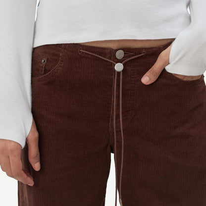 Still Here cool chocolate corduroy denim jeans, front view showing fit and texture of the chocolate-colored fabric.