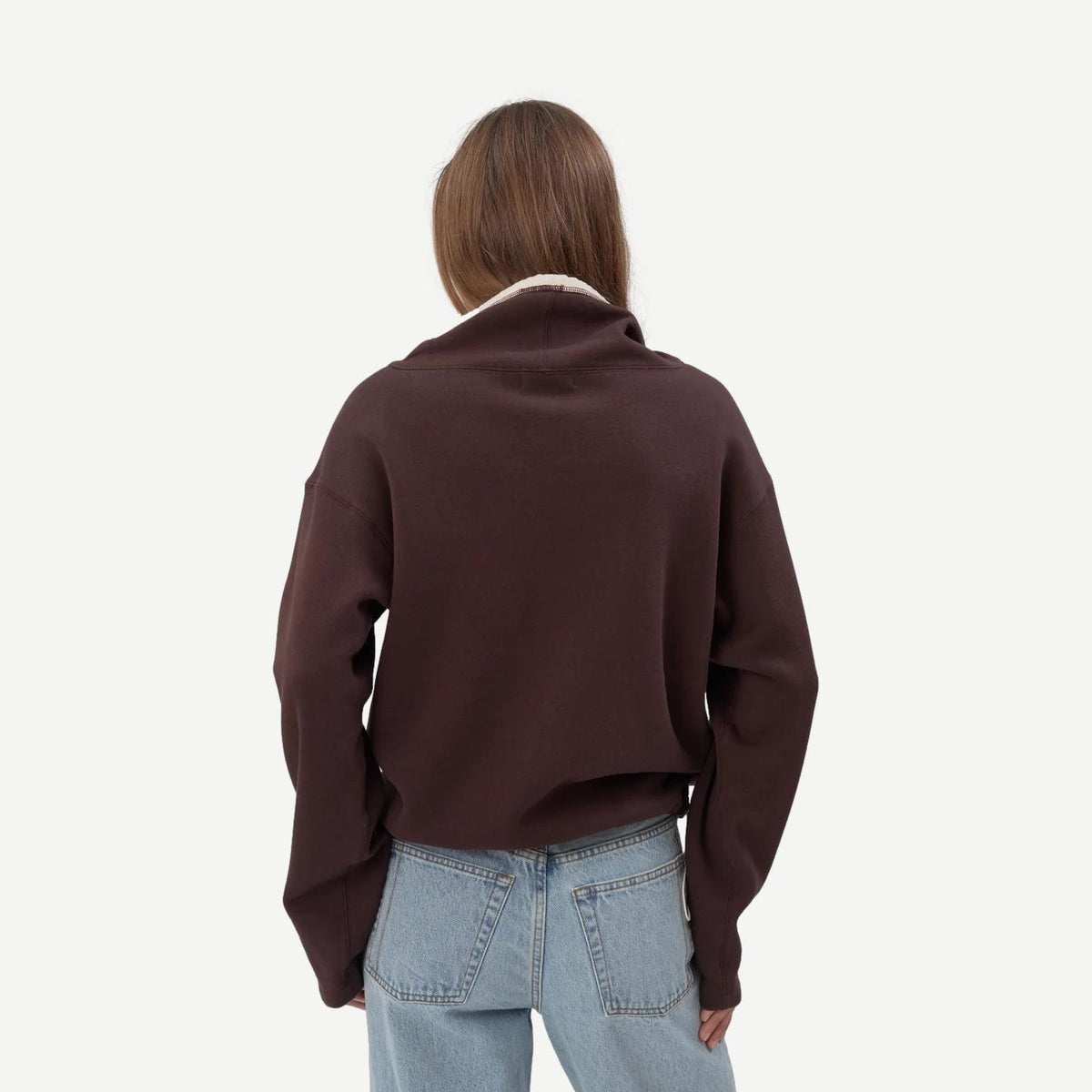 Chocolate brown Still Here Rec Pullover sweatshirt with a relaxed fit and soft fabric, shown on a hanger.