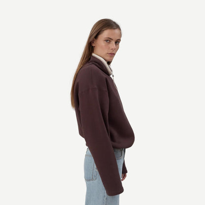 Still Here chocolate brown Rec Pullover sweatshirt with a relaxed fit, shown on a model in a casual setting.