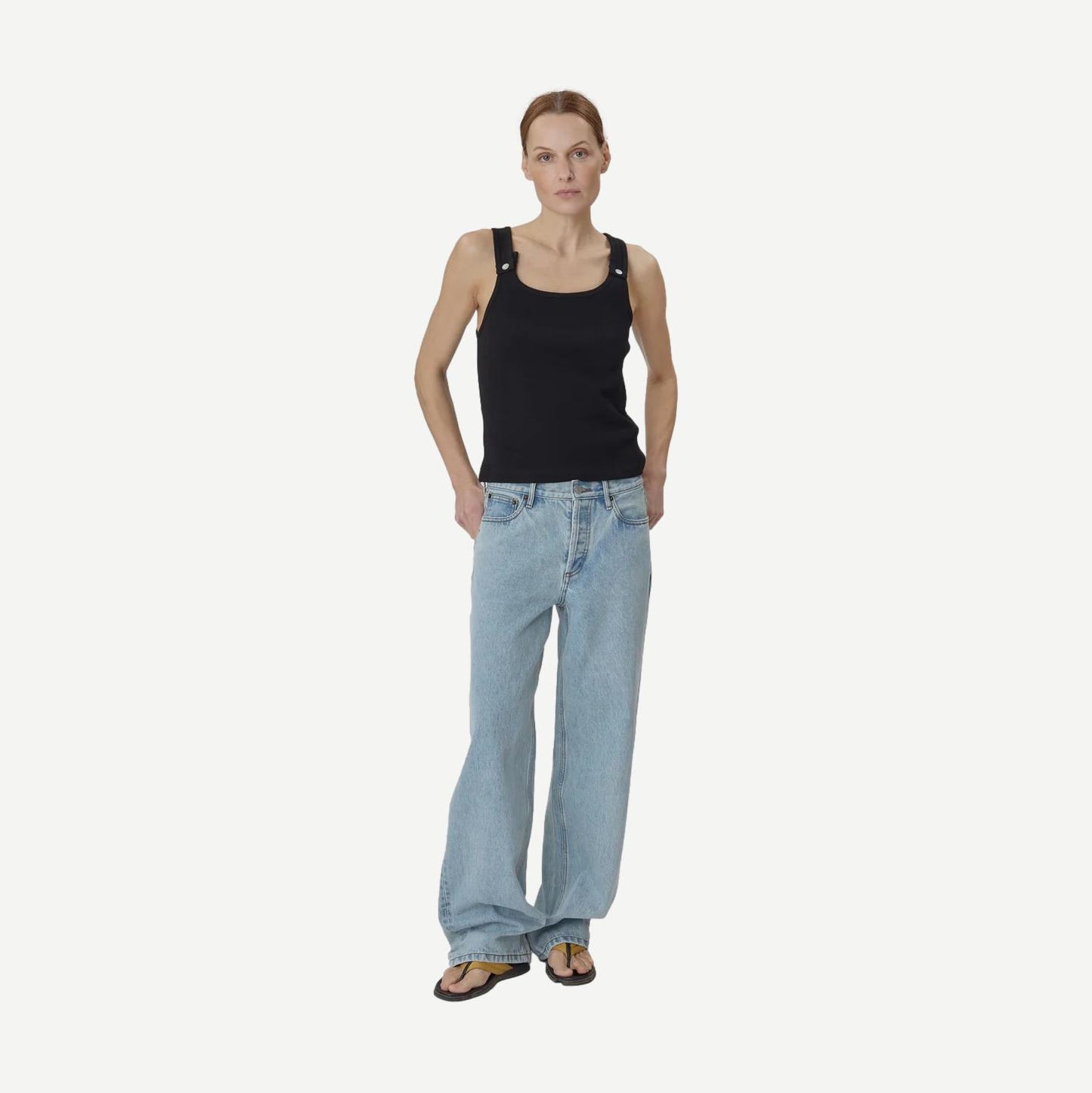 Still Here black Snap Tank top, sleeveless casual tank with a relaxed fit, shown on a model.