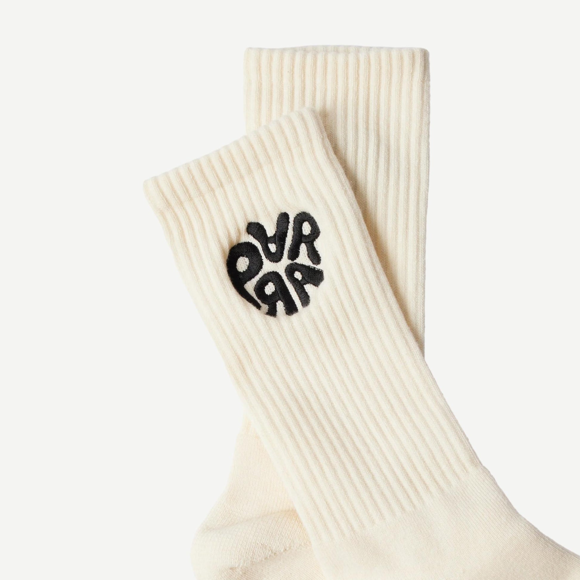Off-white crew socks by By Parra featuring the 1976 logo design, made of soft, comfortable fabric.