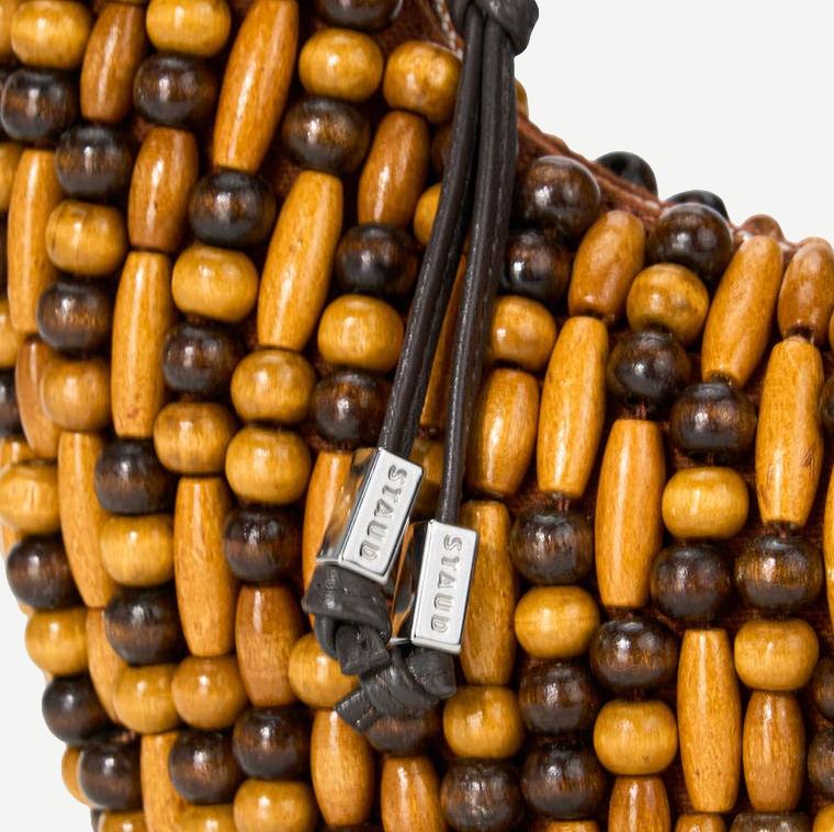 Staud Reef Bag with multicolored wood bead details, stylish purse with woven texture and wooden handles.