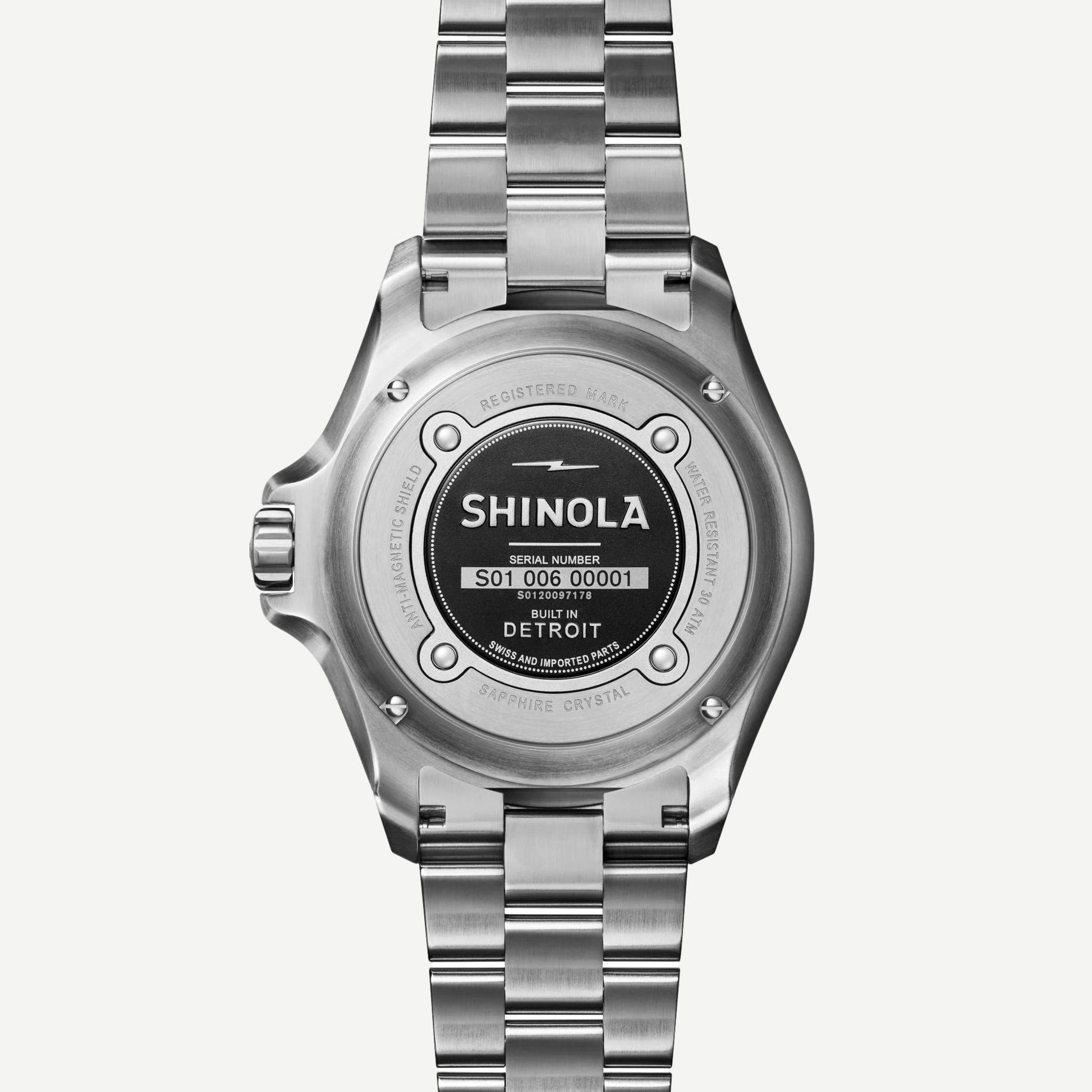 Shinola Monster Automatic Lake Michigan 39mm watch with blue dial, mother-of-pearl accents, silver case, and leather strap.