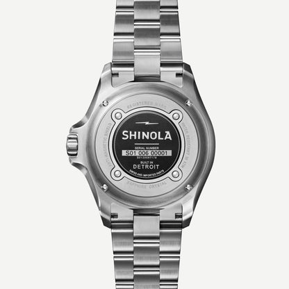 Shinola Monster Automatic Lake Michigan 39mm watch with blue dial, mother-of-pearl accents, silver case, and leather strap.