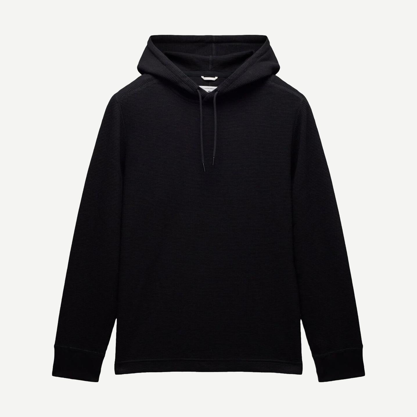 Reigning Champ black lightweight waffle hoodie sweatshirt displayed on a hanger, showcasing its soft fabric and casual style.