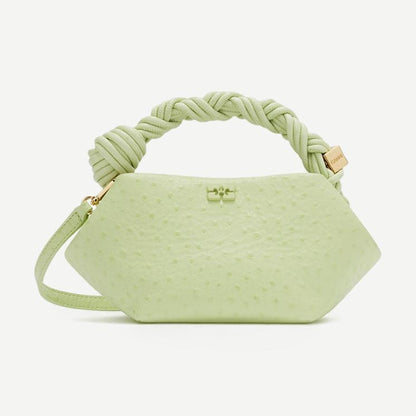 Ganni Bou Mini Ostrich purse in Lily Green with textured ostrich leather and compact design, featuring a top zipper closure.