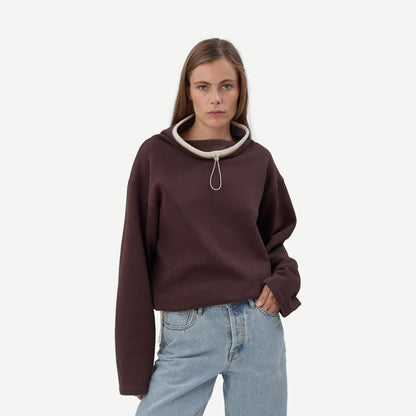 Still Here chocolate brown Rec Pullover sweatshirt with a relaxed fit and soft fabric, displayed on a hanger.