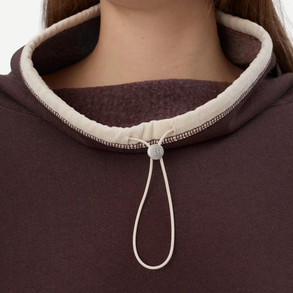 Still Here chocolate brown Rec Pullover sweatshirt, cozy fleece fabric, casual fit, displayed on a hanger.