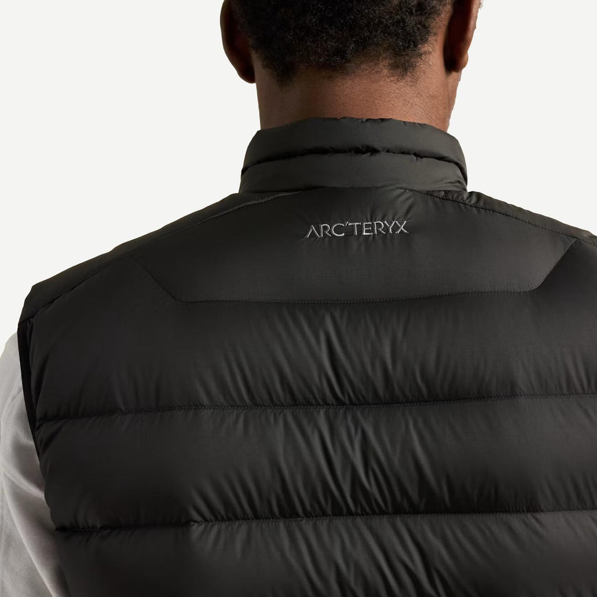 Black Arc'teryx Cerium Vest for men, a lightweight insulated outerwear piece with a sleek design and high-quality construction.