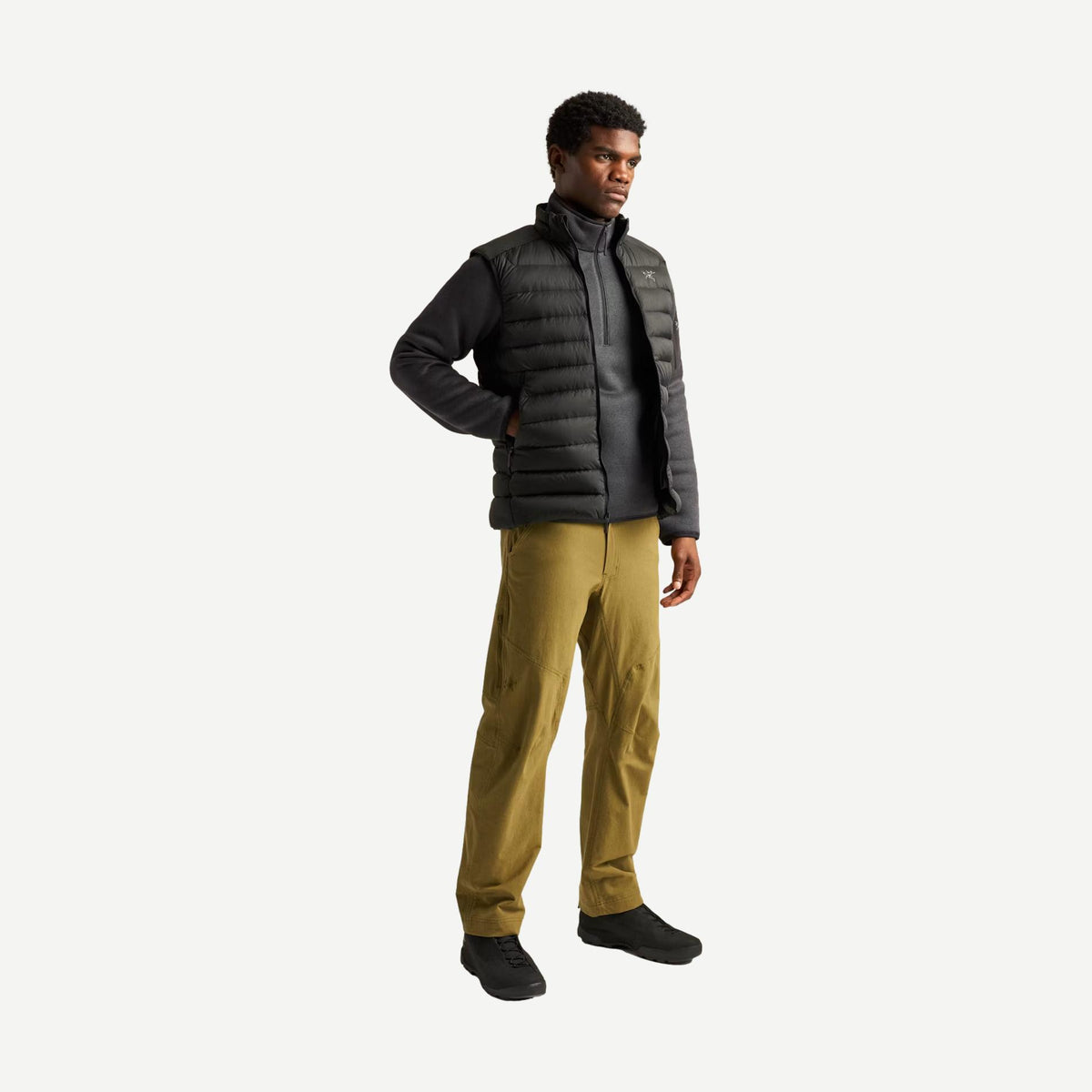 Black Cerium Vest men's outerwear by Arc'teryx shown on a hanger with a sleek, minimalist design and lightweight insulation.