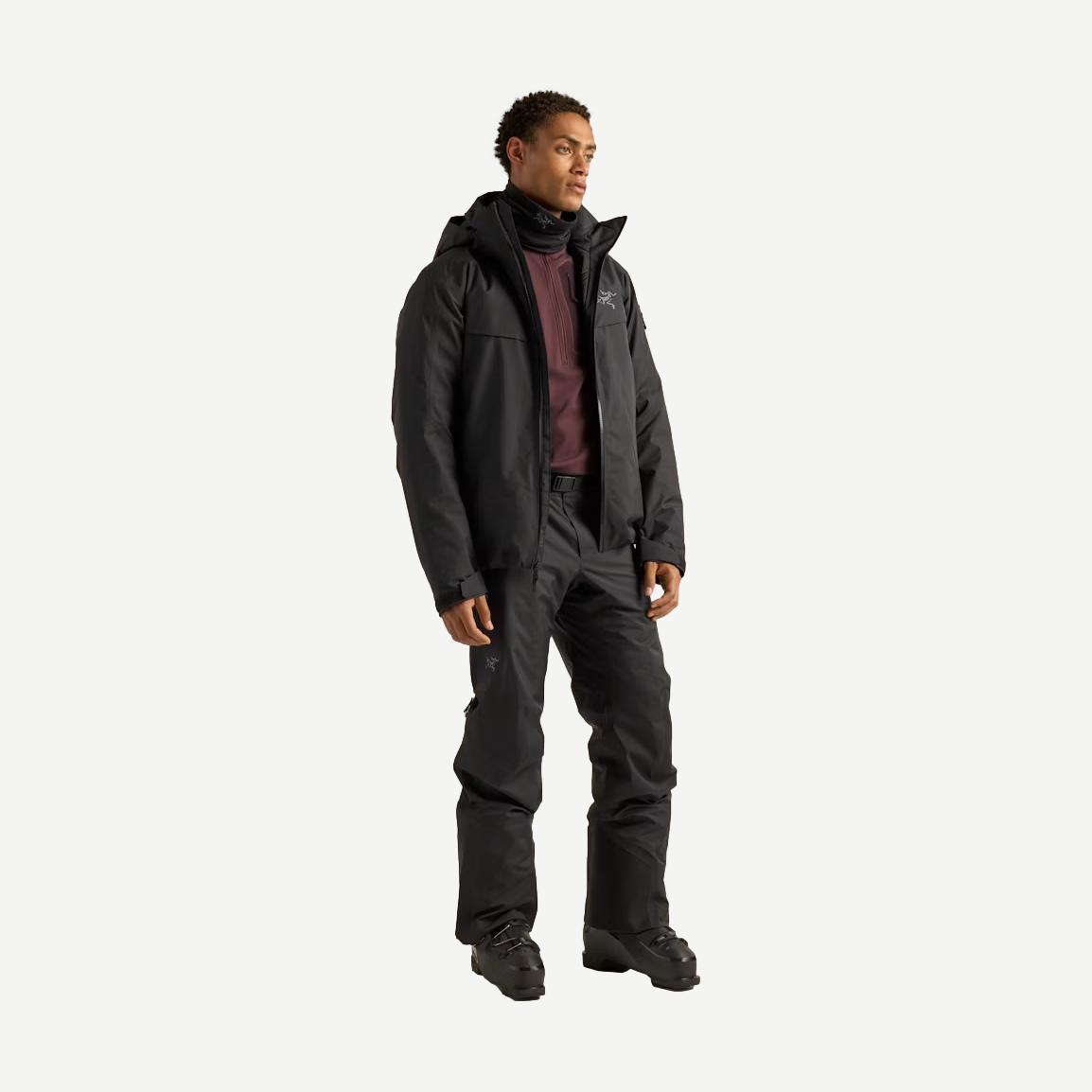 Black Arcteryx Macai Down Jacket for men, stylish outdoor outerwear with insulated down filling, shown on a hanger.