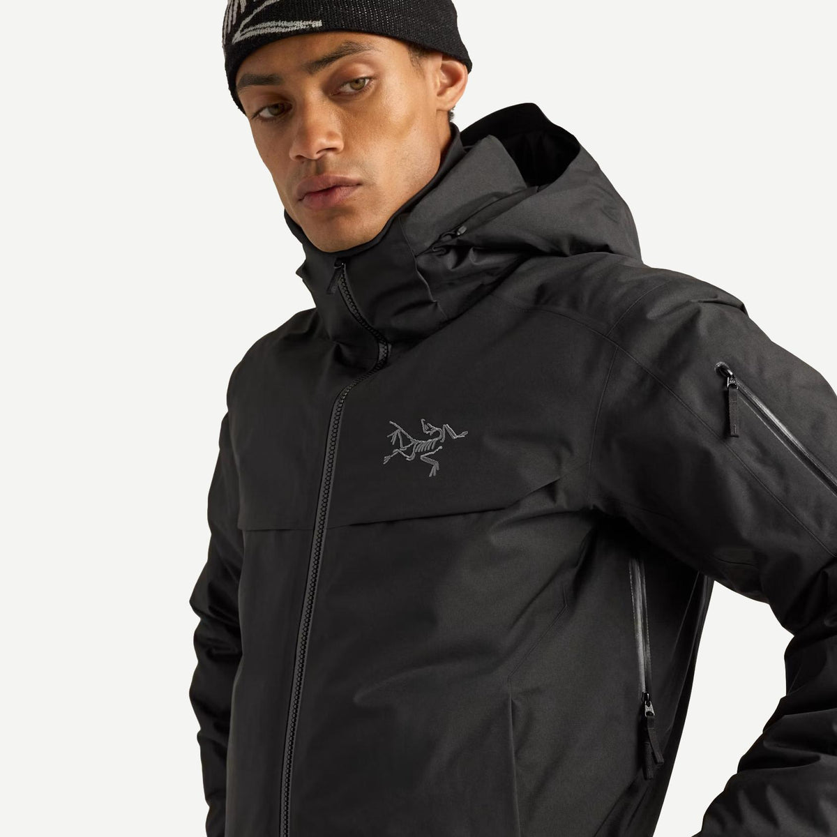 Black Arcteryx Macai Down Jacket for men, stylish outerwear with front pit zips and insulated design.